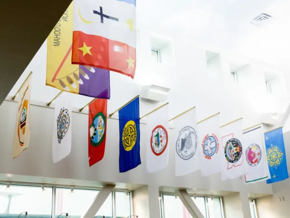 Flags from all of Arizona’s 22 tribal nations are hung in the bookstore at the University of Arizona Student Union Memorial Center. Photo by Chris Richards | University of Arizona