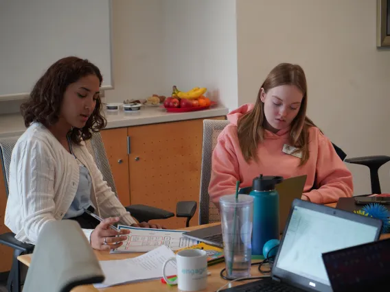 Two students writing assignments.