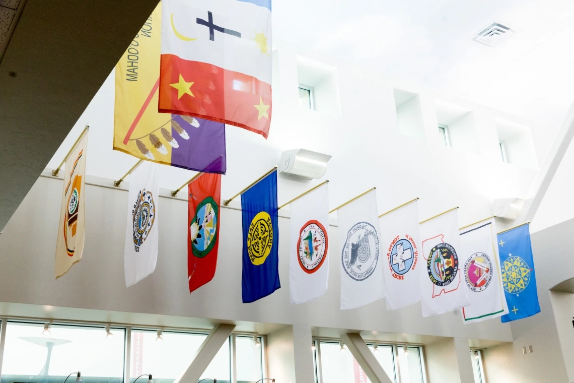 Flags from all of Arizona’s 22 tribal nations are hung in the bookstore at the University of Arizona Student Union Memorial Center. Photo by Chris Richards | University of Arizona