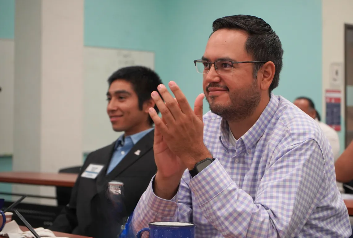 Two Native FORGE conference participants listening to presenter