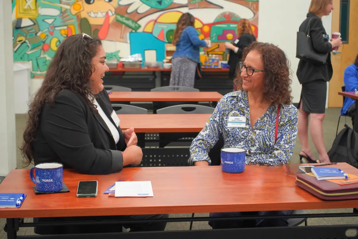 Two Native FORGE conference participants in conversation