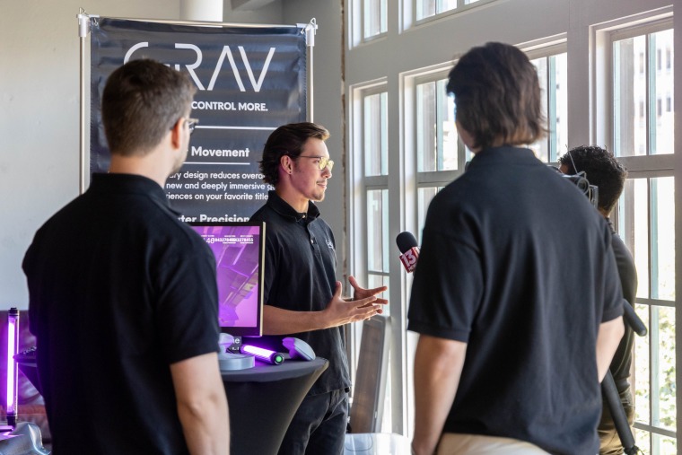 GRAV Founders Newton Ryan, Evan Zavitz, and Armen Demirjian speaking with a news team at a FORGE event.