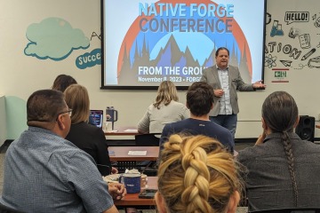 Brian Ellerman in front of Native FORGE Conference slide