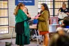 Nicolette Gomez, right, presents a certificate to Suzie Francisco